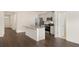 Well-lit kitchen with a center island, stainless steel appliances, and dark hardwood flooring at 1626 Palladian Way, Lithonia, GA 30058