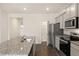 Modern kitchen features granite countertops, stainless steel appliances, and ample cabinet space at 1626 Palladian Way, Lithonia, GA 30058