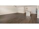 Open-concept living room with hardwood floors and ceiling fan, next to kitchen island at 1626 Palladian Way, Lithonia, GA 30058