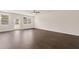 Spacious living room with hardwood floors, bright windows, and access to the patio at 1626 Palladian Way, Lithonia, GA 30058