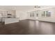 Open layout featuring hardwood floors connecting kitchen with island and the living space at 1626 Palladian Way, Lithonia, GA 30058