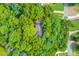 Aerial shot displaying the property nestled among lush, green trees at 4975 Duncans Lake Dr, Buford, GA 30519