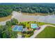Aerial view of community amenities including pools and tennis courts, next to a lake, offering recreational options and scenic views at 4975 Duncans Lake Dr, Buford, GA 30519