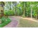 Secluded backyard oasis with mature trees and a brick pathway at 4975 Duncans Lake Dr, Buford, GA 30519
