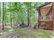 Backyard featuring a stone pathway, terraced planting beds, and mature trees, leading to covered deck at 4975 Duncans Lake Dr, Buford, GA 30519