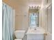 Neutral bathroom featuring vanity with bright lighting, faucet, mirror, and blue shower curtain at 4975 Duncans Lake Dr, Buford, GA 30519