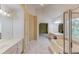 Bathroom featuring dual vanities, soaking tub, and tiled floors at 4975 Duncans Lake Dr, Buford, GA 30519