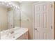 Bathroom features vanity with bright lighting and neutral paint at 4975 Duncans Lake Dr, Buford, GA 30519