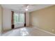 Inviting bedroom with large window and curtains, neutral paint, and plush carpeting at 4975 Duncans Lake Dr, Buford, GA 30519