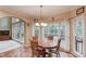 Cozy breakfast nook with many windows and wood table at 4975 Duncans Lake Dr, Buford, GA 30519
