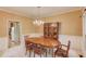 Traditional dining room with wood table, china cabinet, and elegant chandelier lighting at 4975 Duncans Lake Dr, Buford, GA 30519