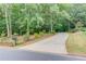 Long driveway leading to a property, enhanced by mature landscaping and green lawns, and a decorative mailbox at roadside at 4975 Duncans Lake Dr, Buford, GA 30519