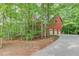 Brick home with three-car garage, surrounded by lush trees and a long driveway at 4975 Duncans Lake Dr, Buford, GA 30519