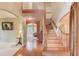 Entryway with wooden staircase, beautiful archways, and hardwood flooring at 4975 Duncans Lake Dr, Buford, GA 30519