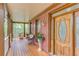 Covered front porch with decorative glass front door and room for seating, brick walls at 4975 Duncans Lake Dr, Buford, GA 30519