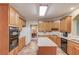 Bright kitchen with modern appliances, tile flooring, and granite countertops at 4975 Duncans Lake Dr, Buford, GA 30519