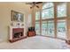 Sun-filled living room with high ceilings, large windows, and brick fireplace at 4975 Duncans Lake Dr, Buford, GA 30519