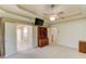 Spacious main bedroom featuring tray ceiling, ceiling fan, and built-ins at 4975 Duncans Lake Dr, Buford, GA 30519