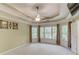 Spacious main bedroom with tray ceiling, fan, and large windows at 4975 Duncans Lake Dr, Buford, GA 30519