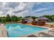 Community pool area with lounging chairs, shaded gazebos, and meticulous landscaping, creating a perfect spot for relaxation at 4975 Duncans Lake Dr, Buford, GA 30519