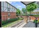 View from balcony overlooking green space, and exterior of building with brick facade at 6851 Roswell Rd # E4, Atlanta, GA 30328