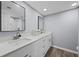 Bright bathroom featuring double sinks, white cabinetry, and modern fixtures at 6851 Roswell Rd # E4, Atlanta, GA 30328