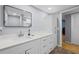 Bathroom featuring a gray wall, white cabinets, and wood floors at 6851 Roswell Rd # E4, Atlanta, GA 30328