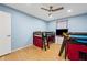 Bedroom featuring light blue walls, wood floors, bunkbeds, and a ceiling fan at 6851 Roswell Rd # E4, Atlanta, GA 30328