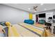 Comfortable bedroom showcasing hardwood floors, a yellow-themed bed, and a sitting area at 6851 Roswell Rd # E4, Atlanta, GA 30328