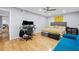 Bedroom with wood floors, gray walls, and a yellow-themed bed with a cozy sitting area at 6851 Roswell Rd # E4, Atlanta, GA 30328
