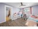 Cozy bedroom showcasing pale purple walls, wood floors, ample storage, and a tranquil window view at 6851 Roswell Rd # E4, Atlanta, GA 30328