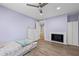 Bedroom featuring wood floors, pale purple walls, and a fireplace at 6851 Roswell Rd # E4, Atlanta, GA 30328
