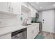 Contemporary kitchen showcasing white cabinets, stainless steel appliances, and a subway tile backsplash at 6851 Roswell Rd # E4, Atlanta, GA 30328