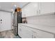 Updated kitchen with white cabinetry, stainless steel refrigerator, and subway tile backsplash at 6851 Roswell Rd # E4, Atlanta, GA 30328
