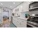 Modern kitchen featuring white cabinets, stainless steel appliances, and a subway tile backsplash at 6851 Roswell Rd # E4, Atlanta, GA 30328