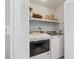 Bright laundry room featuring a white washer and dryer, and shelving for storage at 6851 Roswell Rd # E4, Atlanta, GA 30328
