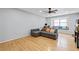 Inviting living space with hardwood floors, a gray sofa, a window seat, and natural light at 6851 Roswell Rd # E4, Atlanta, GA 30328