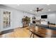 Hardwood flooring, light-filled living space with gray sofa, and door to the exterior at 6851 Roswell Rd # E4, Atlanta, GA 30328