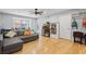 Bright living room with hardwood floors, gray sofa, window seating, and a decorative bookshelf at 6851 Roswell Rd # E4, Atlanta, GA 30328