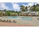 Large community pool surrounded by lounge chairs and lush greenery at 6851 Roswell Rd # E4, Atlanta, GA 30328