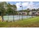 Well-maintained community tennis courts surrounded by fencing and green lawn at 6851 Roswell Rd # E4, Atlanta, GA 30328