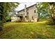 Large grassy backyard with a deck and partial view of the house at 1045 Paper Creek Dr, Lawrenceville, GA 30046