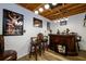 Finished basement bar area with dark wood decor, art and overhead lights at 1045 Paper Creek Dr, Lawrenceville, GA 30046