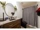Stylish bathroom with granite countertop, dark wood vanity, and black and white shower curtain at 1045 Paper Creek Dr, Lawrenceville, GA 30046