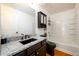 Bathroom featuring a black granite sink, black toilet, and white tile shower/tub at 1045 Paper Creek Dr, Lawrenceville, GA 30046