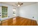 Bedroom with hardwood floors, two windows with blinds, and a ceiling fan at 1045 Paper Creek Dr, Lawrenceville, GA 30046