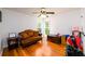 Bright bedroom with hardwood floors and natural light from two windows at 1045 Paper Creek Dr, Lawrenceville, GA 30046