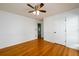 Bedroom with hardwood floors, a ceiling fan, and white trim at 1045 Paper Creek Dr, Lawrenceville, GA 30046