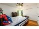 Bedroom with hardwood floors, a ceiling fan, and two windows providing natural light at 1045 Paper Creek Dr, Lawrenceville, GA 30046