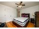 Bedroom with hardwood floors, a ceiling fan, and a bed with storage at 1045 Paper Creek Dr, Lawrenceville, GA 30046
